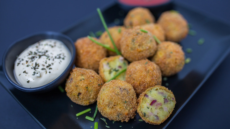 Deep-fried egg balls served with sauce.