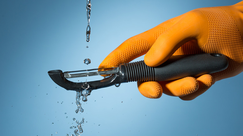 washing a vegetable peeler
