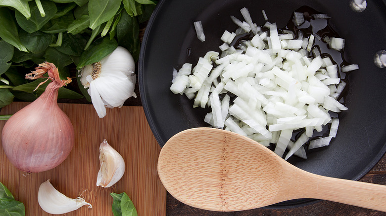 Onion in pan with spoon