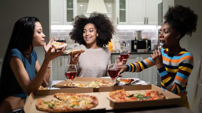 friends sharing wine and pizzza