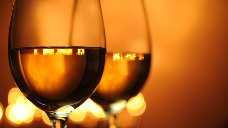 2 glasses of wine and with lights in the background