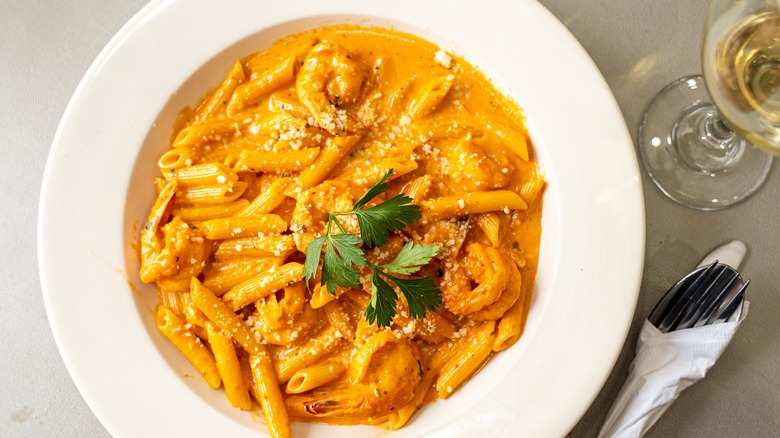 Pasta alla vodka with glass of white wine