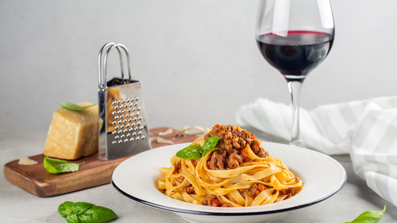 Pasta Bolognese with glass of red wine