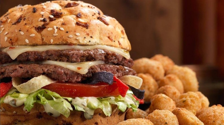 A Culver's Pepper Jack Ranch Pub Burger sits next to a pile of cheese curds