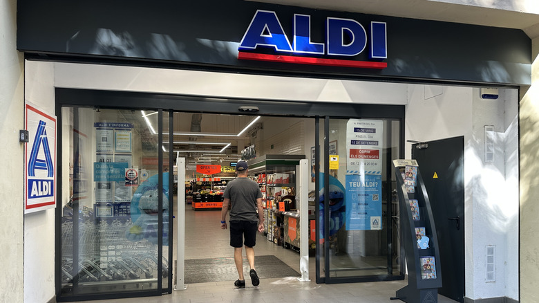 Aldi storefront with a man walking in