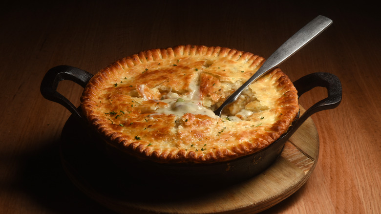 savory chicken pot pie with metal spoon in middle