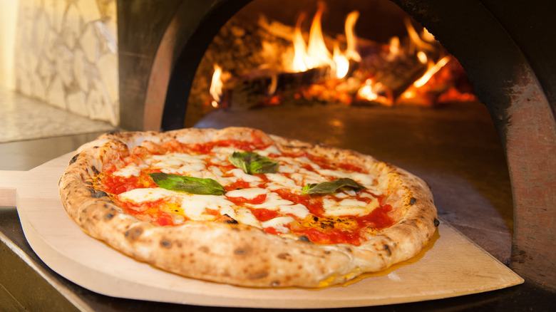 Neapolitan pizza coming out of the oven