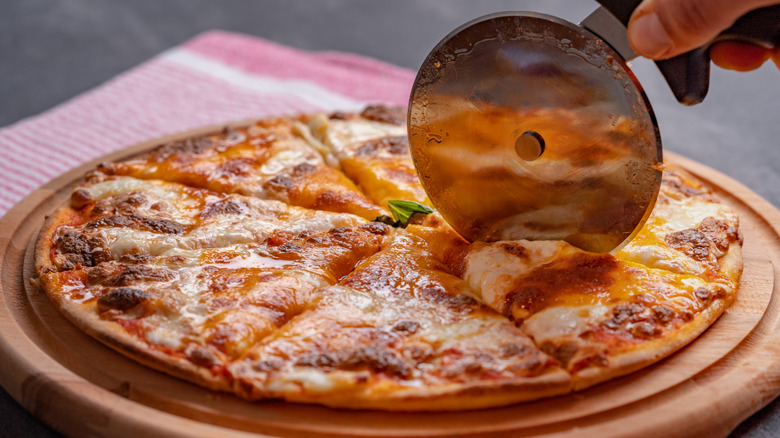 Cutting pizza with slicer