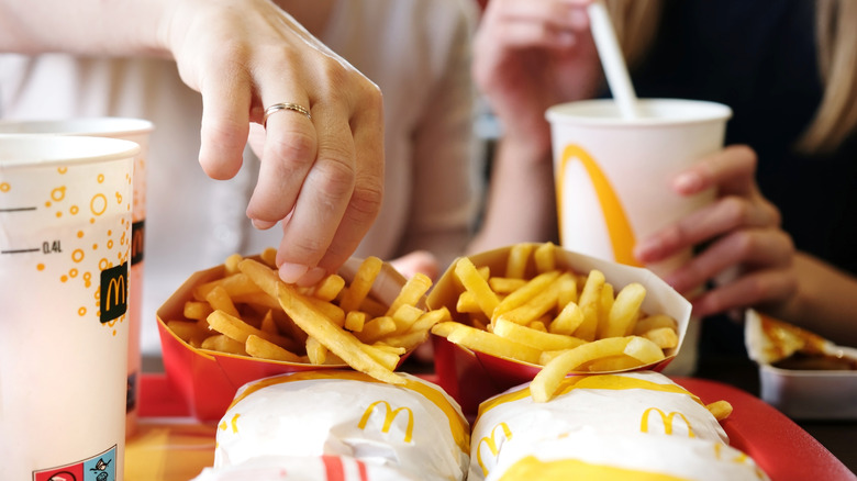 Close up of two women at a McDonald's with a tray of fast food