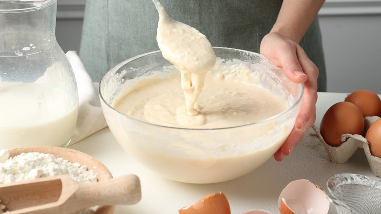 Someone mixes up pancake batter.