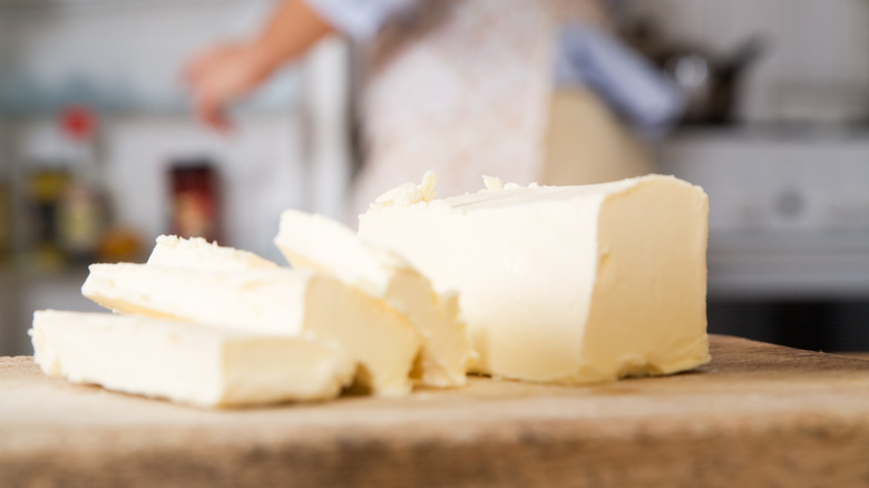 Slices of butter on wooden slab