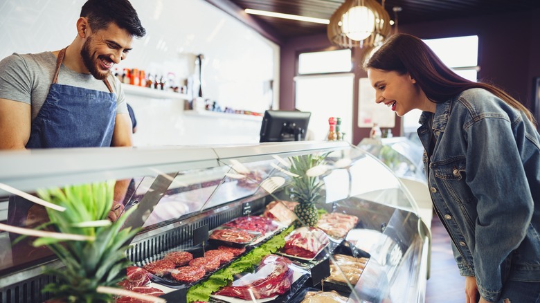 person shopping for meat at a butcher counter