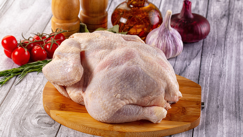 A whole chicken on a cutting board