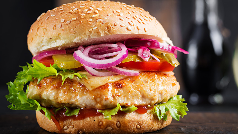 Turkey burger with veggies on sesame bun