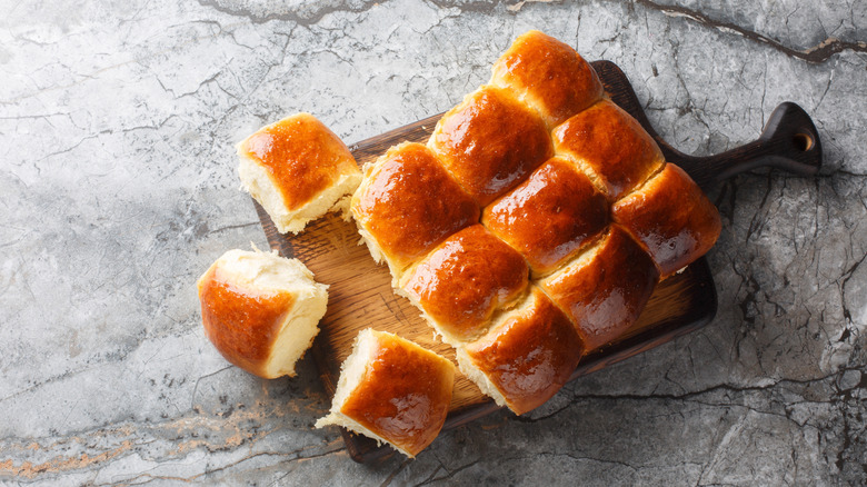 buttery dinner rolls on wooden board