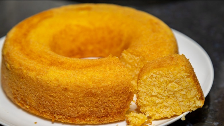 Yellow-orange bundt cake on white plate