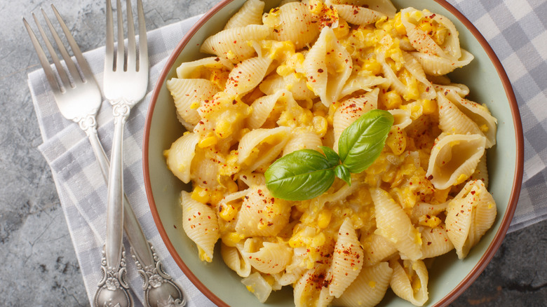Mac and cheese with corn sits in a bowl.