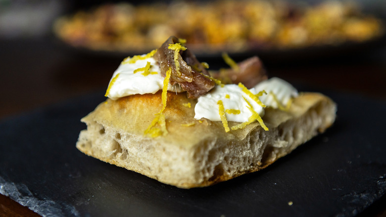 Cheese and anchovies on focaccia bread.