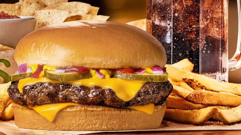 Chili's new Big QP burger, pictured alongside fries, a drink, and bottomless chips and salsa