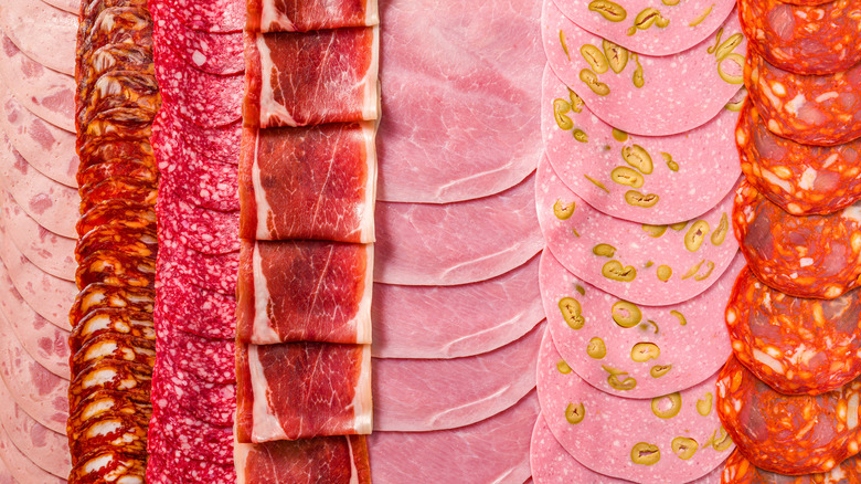 Various slices of deli meats arranged side-by-side in vertical lines