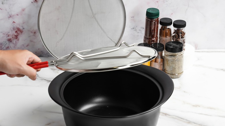 Pot with a splatter screen across the top 