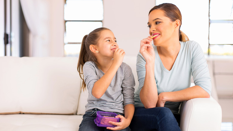 Parent and child eating crackers