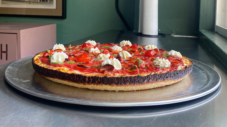 Milly's pizza with pepperoni, pesto, and cheese dollops