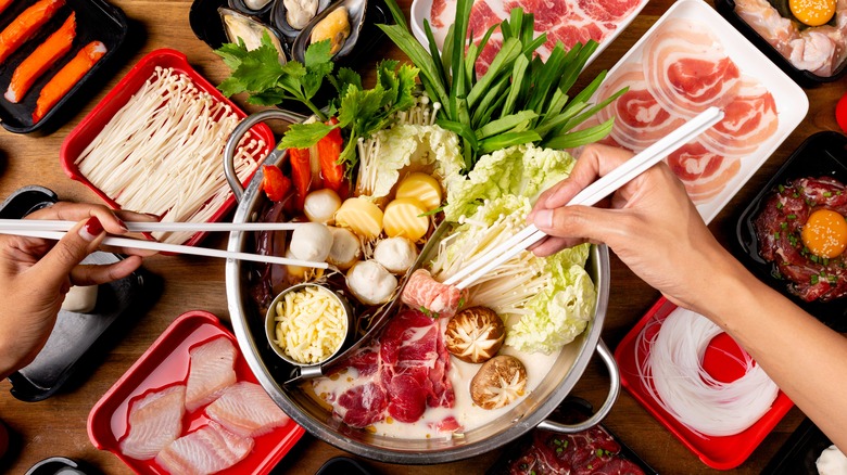 People eating hot pot with chopsticks