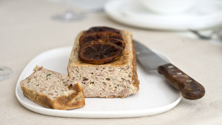 Sliced tuna loaf garnished with lemon