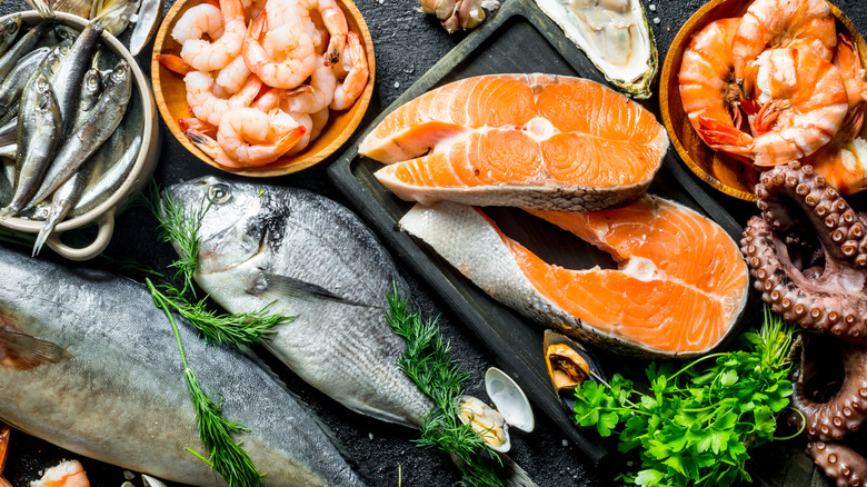 Various seafood including salmon, shrimp, and sardines