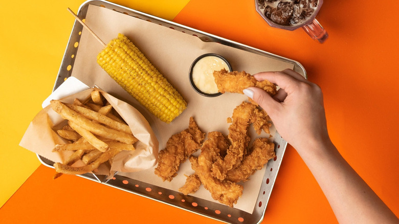 Chicken Crispers from Chili's served with dipping sauce, corn, and fries