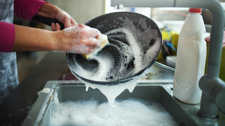 Person cleaning pan