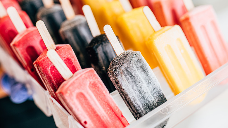 Different flavors of popsicles in a bin 