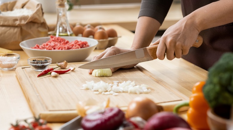 Sharp knife cutting onion