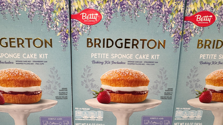A row of Bridgerton themed boxed cake mixes sit in a grocery store aisle