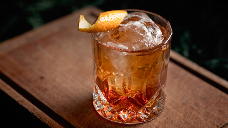 Cocktail in glass with ice and twist