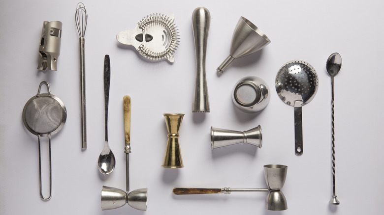 assortment of bar tools and cocktail spoon