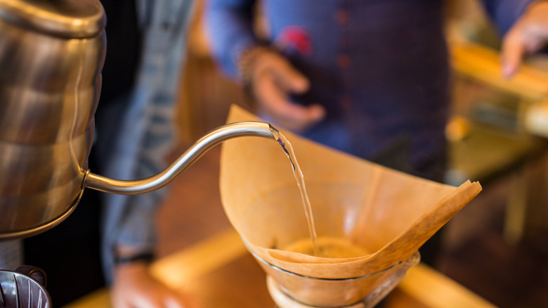 pouring water onto coffee filter