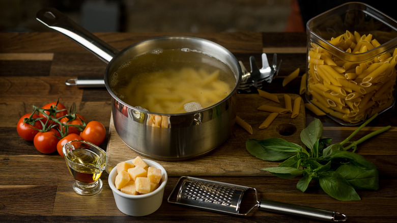 Penne pasta about to be cooked in pan of water