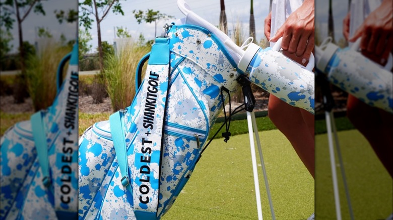 A Coldest brand water bottle next to a matching golf bag