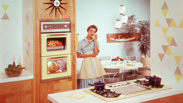 Someone from the 1950s in a vintage kitchen while cooking
