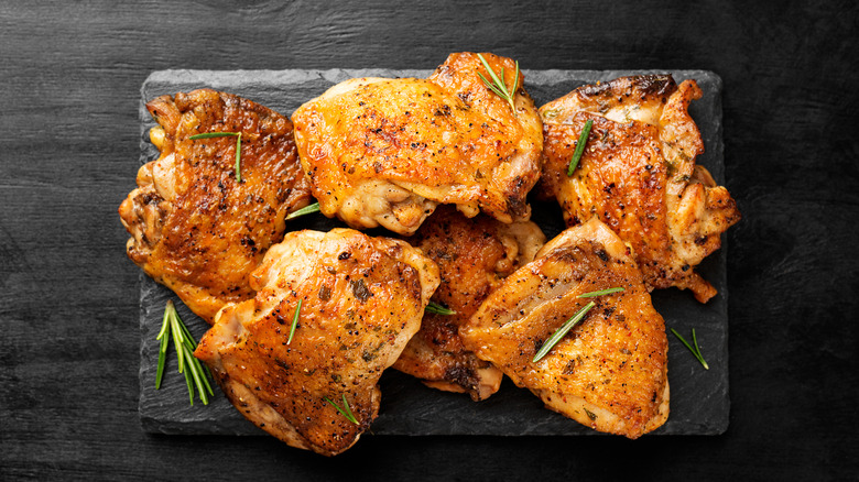 grilled chicken thighs on a stone