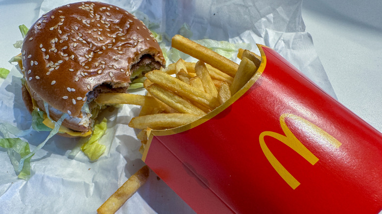A McDonald's meal consisting of a half-eaten Big Mac and fries.