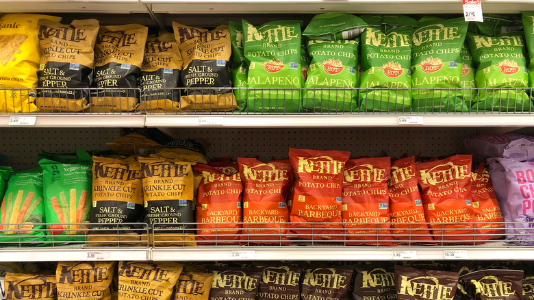 An aisle at the grocery store filled with Kettle brand chips.