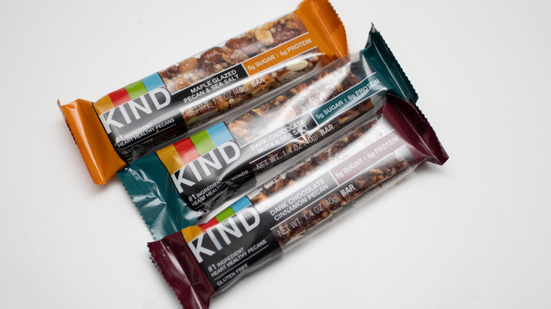 Three Kind brand nut bars on white surface