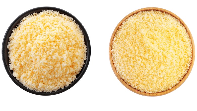 Grated parmesan cheese on white background