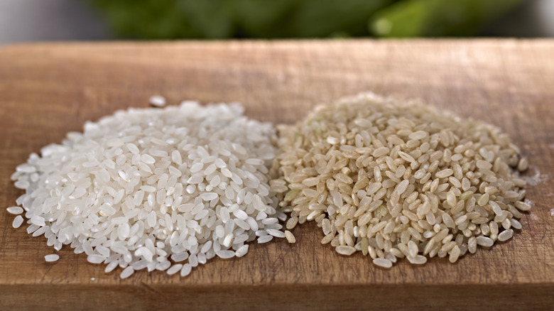 Piles of brown and white rice