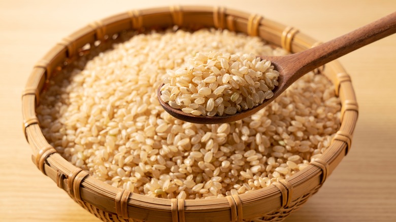 A bowl of brown rice with a spoon