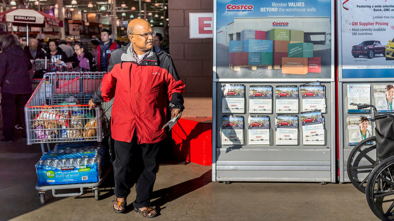 Someone walking out of Costco with a full cart