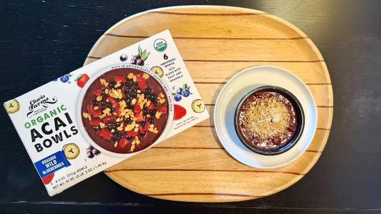 A box of Clovis Farms açaí bowls sits next to a thawed bowl with granola.